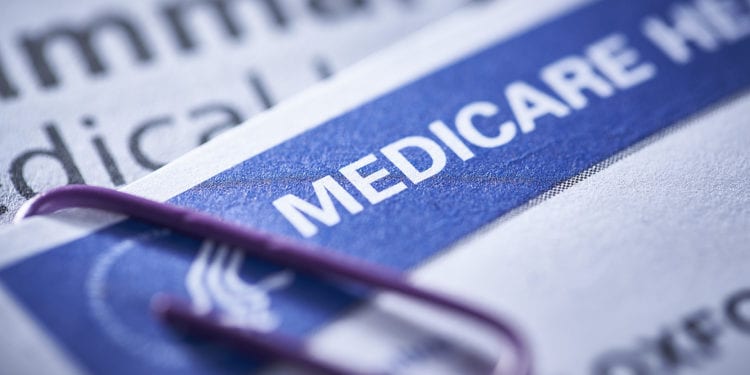 closeup of a Medicare health insurance card with a paperclip