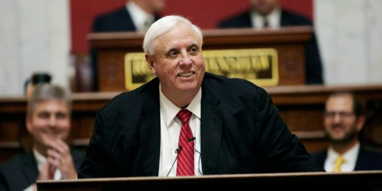 FILE - In this Jan. 8, 2020, file photo, West Virginia Gov. Jim Justice delivers his annual State of the State address in the House Chambers at the state capitol in Charleston, W.Va.  Justice has signed a largely symbolic measure to penalize physicians who don't provide medical care to a child born after an abortion. The Republican signed the bill into law at a ceremony Monday, March 2, 2020.  (AP Photo/Chris Jackson, File)