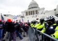 Trump supporters try to break through a police barrier, Wednesday, Jan. 6, 2021, at the Capitol in Washington. As Congress prepares to affirm President-elect Joe Biden's victory, thousands of people have gathered to show their support for President Donald Trump and his claims of election fraud. (AP Photo/Julio Cortez)