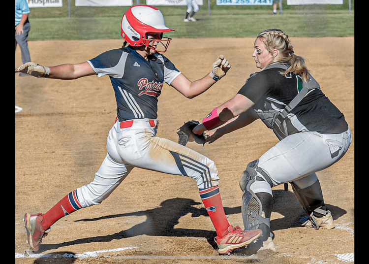 Independence’s Alli Hypes, left, scores as Wyoming East catcher Paige Laxton waits for the throw during Wednesday action in Coal City. (F. Brian Ferguson/Lootpress)