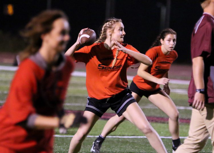 (Brad Davis/For LootPress) Woodrow Wilson Powderpuff Throwdown Seniors (orange) versus Sophomores (tie-dye) Monday night at Van Meter Stadium.