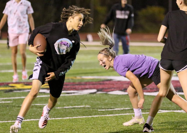 (Brad Davis/For LootPress) Woodrow Wilson Powderpuff Throwdown Freshmen (purple) versus Juniors (black) Monday night at Van Meter Stadium.