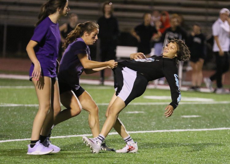 (Brad Davis/For LootPress) Woodrow Wilson Powderpuff Throwdown Freshmen (purple) versus Juniors (black) Monday night at Van Meter Stadium.