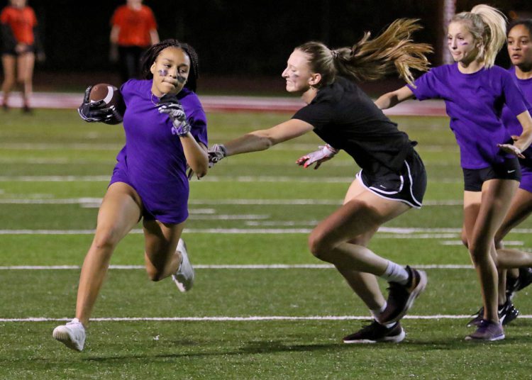 (Brad Davis/For LootPress) Woodrow Wilson Powderpuff Throwdown Freshmen (purple) versus Juniors (black) Monday night at Van Meter Stadium.