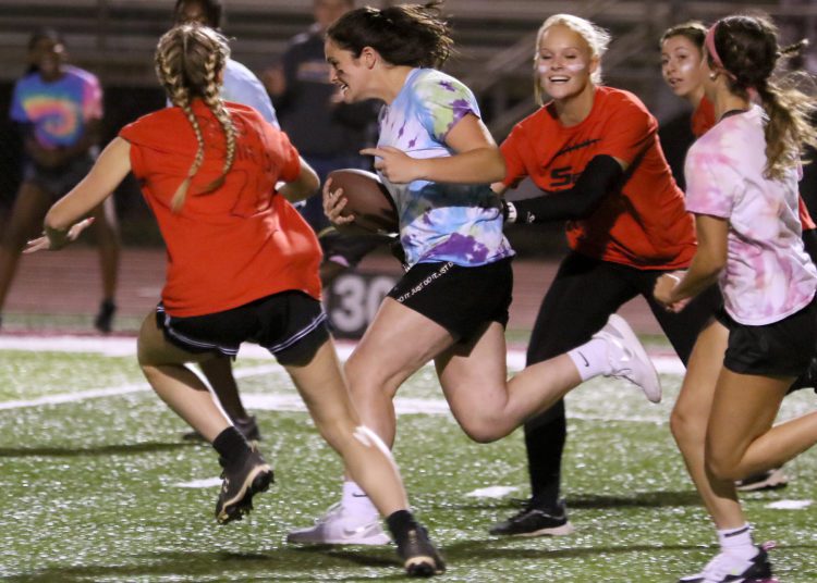 (Brad Davis/For LootPress) Woodrow Wilson Powderpuff Throwdown Seniors (orange) versus Sophomores (tie-dye) Monday night at Van Meter Stadium.