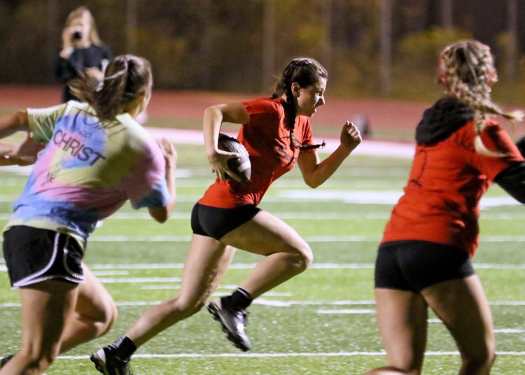 (Brad Davis/For LootPress) Woodrow Wilson Powderpuff Throwdown Seniors (orange) versus Sophomores (tie-dye) Monday night at Van Meter Stadium.