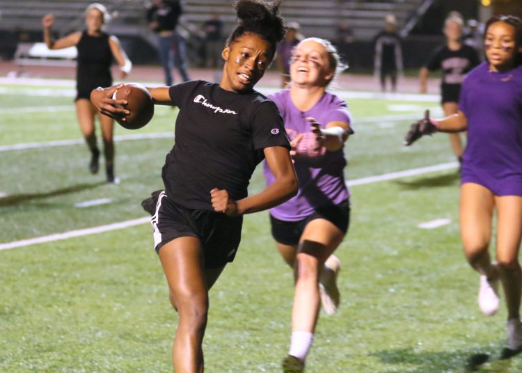 (Brad Davis/For LootPress) Woodrow Wilson Powderpuff Throwdown Freshmen (purple) versus Juniors (black) Monday night at Van Meter Stadium.