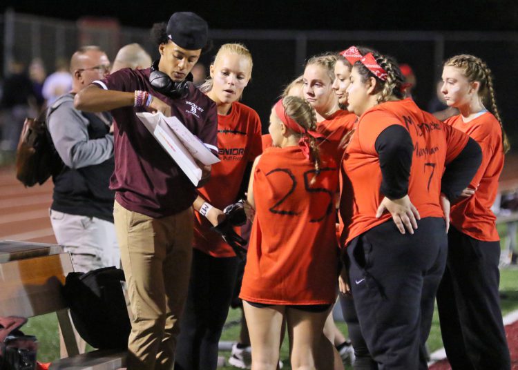 (Brad Davis/For LootPress) Woodrow Wilson Powderpuff Throwdown Seniors (orange) versus Sophomores (tie-dye) Monday night at Van Meter Stadium.