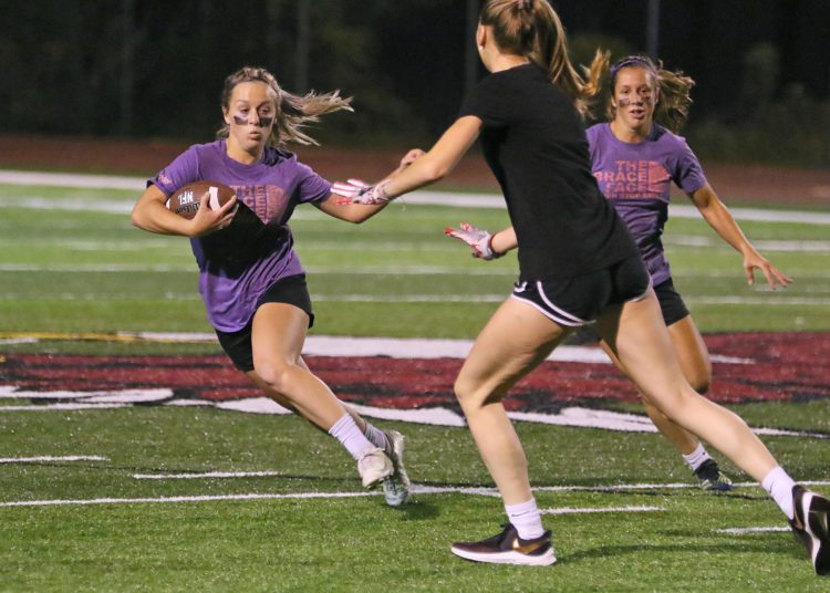 (Brad Davis/For LootPress) Woodrow Wilson Powderpuff Throwdown Freshmen (purple) versus Juniors (black) Monday night at Van Meter Stadium.