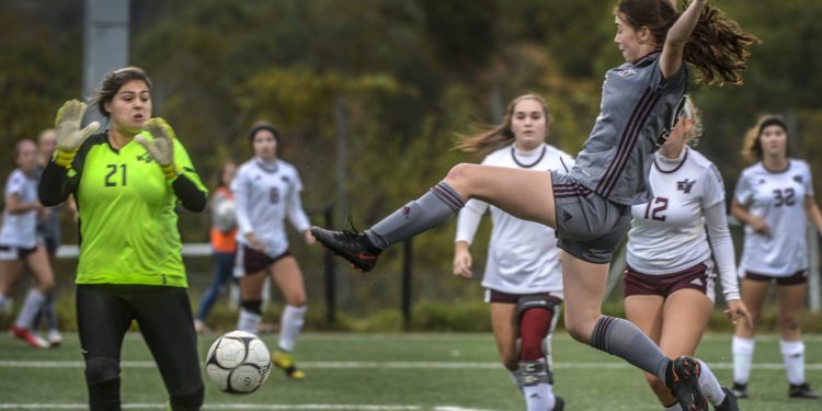 (KENNY KEMP | Gazette-Mail)
George Washington's Katherine Akers (right) kicks in the Patriots' first goal in their 3-1 win over Woodrow Wilson in the Class AAA Region 3 girls soccer championship game Thursday at Trace Fork.