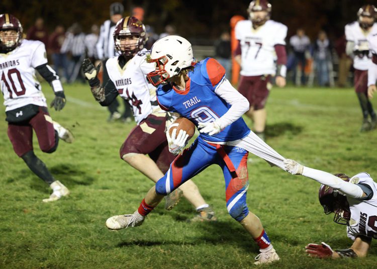 Midland Trail’s Cody Harrell (9) is pulled down by Pocahontas County’s Clayton Burns (80) during their high school football game in Hico on Friday, Nov. 5, 2021 (Photo by Chris Jackson)