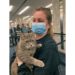 In this photo provided by Janet Williams, "Ashes" the cat, who had been lost by a Maine family since 2015, is held by Williams at Tampa International Airport, Wednesday Feb. 9, 2022, in Tampa, Fla. Denise Cilley, of Chesterville, Maine, says she was shocked to get a voicemail last week announcing her cat, Ashes, had been found nearly 1,500 miles away in Florida. Ashes is being returned to Maine on Wednesday, with Cilley planning to be on hand to collect her pet at Portland International Jetport. (Janet Williams via AP)