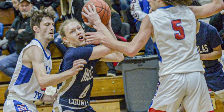 Midland Trail’s Matthew Light, left, and John Paul Morrison, right, defend as Nicholas County’s Colby Pishner drives for the score. F. Brian Ferguson/Lootpress.