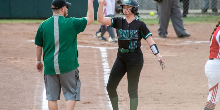 Wyoming East's Olivia Hylton high fives assistant coach Travis McKinney during a game against Independence on March 30. (Heather Belcher)