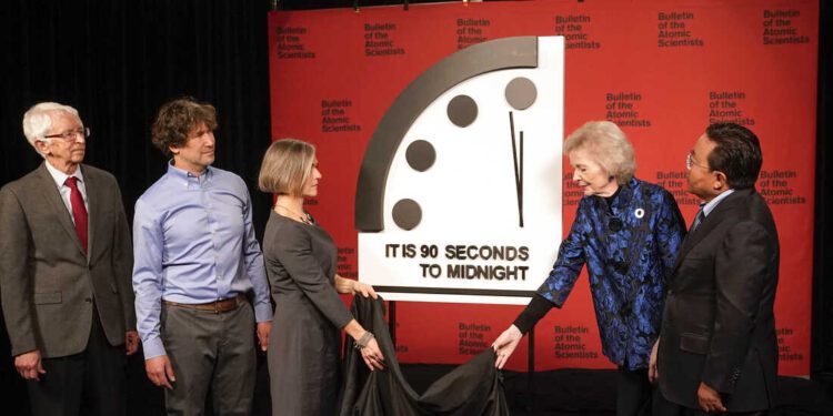 Siegfried Hecker, from left, Daniel Holz, Sharon Squassoni, Mary Robinson and Elbegdorj Tsakhia with the Bulletin of the Atomic Scientists, remove a cloth covering the Doomsday Clock before a virtual news conference at the National Press Club in Washington, Tuesday, Jan. 24, 2023. The Bulletin of the Atomic Scientists announced that it has moved the minute hand of the Doomsday Clock to 90 seconds to midnight. (AP Photo/Patrick Semansky)