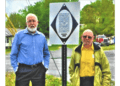 Standing beside the newly Installed marker are project manager Delbert Bailey (left) and Ricky Bryson, a church deacon.