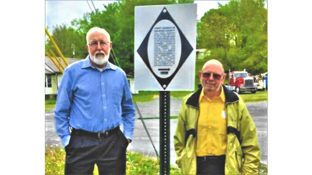 Standing beside the newly Installed marker are project manager Delbert Bailey (left) and Ricky Bryson, a church deacon.