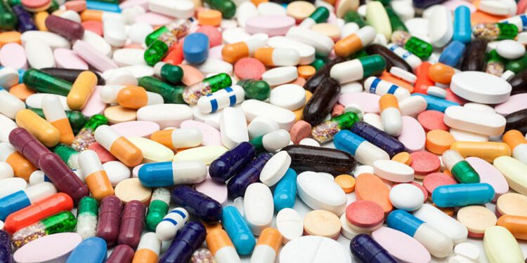 Many colorful medicines. Pills and capsules on white background
