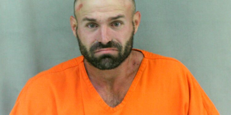 A man was arrested after he was naked and acting in a sexual nature towards a witness's vehicle