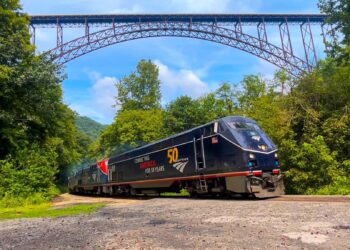 The Amtrak 50 Cardinal bound for New York City flies under the New River Gorge Bridge at South Fayette.