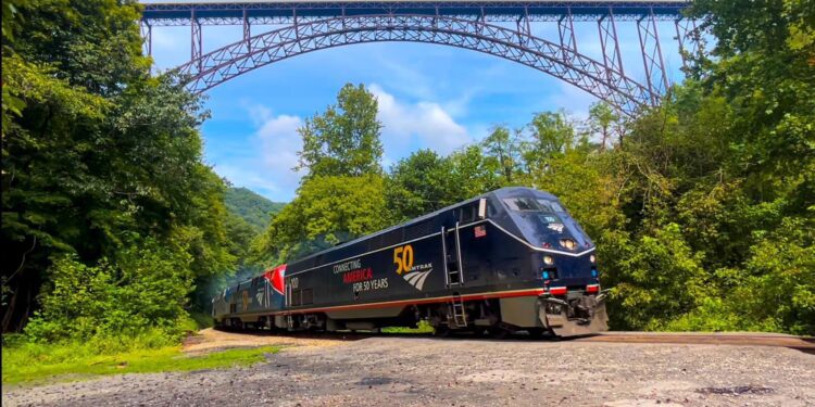 The Amtrak 50 Cardinal bound for New York City flies under the New River Gorge Bridge at South Fayette.