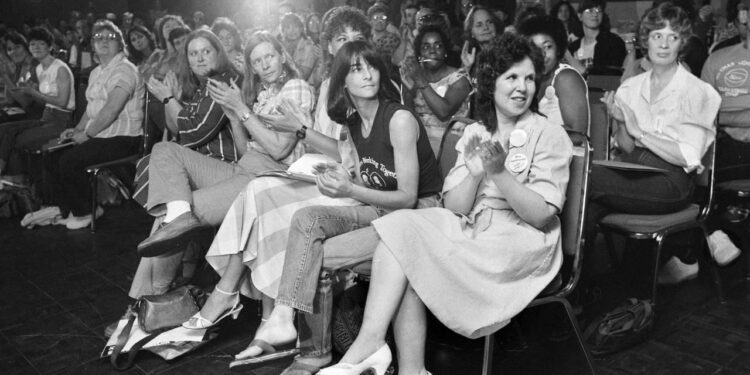 Coal Employment Project Founder Betty Jean Hall, front right, applauds during the Coal Employment Project's annual conference in 1984, in Charleston, W.Va. Hall, an Appalachian attorney and federal administrative judge who paved the way for women to enter the coal mining workforce died at age 78 on Friday, Aug. 16, 2024. (Earl Dotter/UMW Journal via AP)