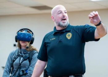 Students test the Apex Officer virtual simulator for de-escalation training during the Criminology open house, March 28, 2023. Photo: Morgan Goff. (Students test the Apex Officer virtual simulator for de-escalation training during the Criminology open