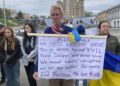 Ryan Wesley Routh holds up a banner during a rally in central Kyiv, Ukraine on Saturday April 30, 2022. (AP Photo/Alex Babenko)