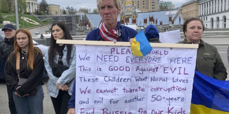 Ryan Wesley Routh holds up a banner during a rally in central Kyiv, Ukraine on Saturday April 30, 2022. (AP Photo/Alex Babenko)