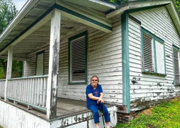 Former Thurmond resident Marilyn Brown sits on the porch of her last residence in Thurmond before moving to Oak Hill after being bought out by the NPS | The “Marilyn Brown House” is one of 19 historic structures proposed for demolition.