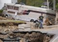 Dominick Gucciardo walks to his home in the aftermath of Hurricane Helene, Thursday, Oct. 3, 2024, in Pensacola, N.C. (AP Photo/Mike Stewart)