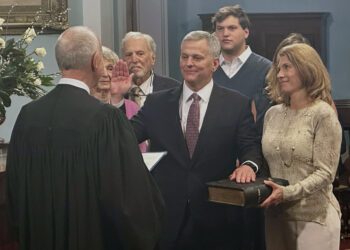 North Carolina Gov. Josh Stein, center, takes the oath of office from state Supreme Court Chief Justice Paul Newby, placing his hand on the Hebrew Bible held by Stein's wife, Anna, in the old Senate chamber of the 1840 Capitol Building in Raleigh, N.C. on Wednesday, Jan. 1 ,2025 (AP Photo/Gary D. Robertson)